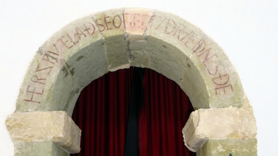 Old English inscription on arch