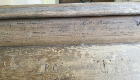 Signature and initials on pew.