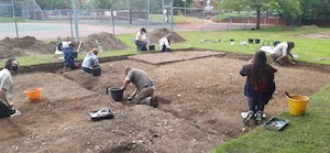 Prof. Josh Pollard and team excavate the remains of a tennis court and WWII air raid shelter on Avenue Campus